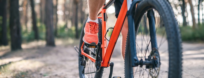 A male cyclist preparing to BMX on a mud path