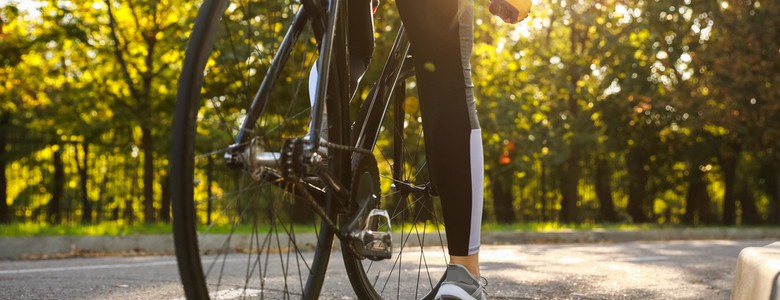 A female cyclist at the side of the road, preparing to ride off