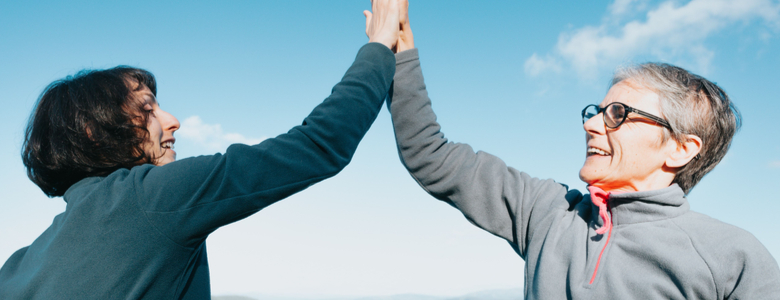 Two women high-fiving