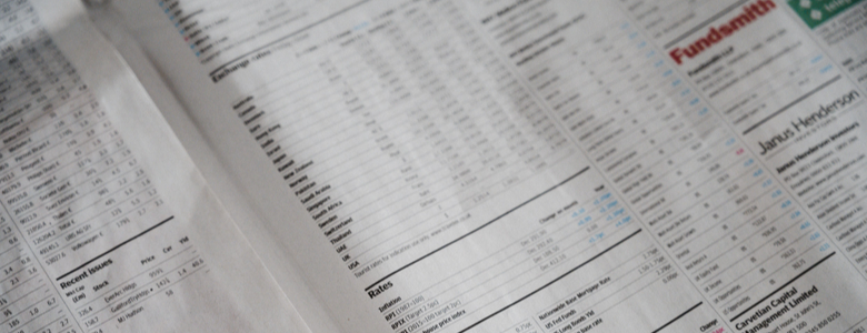 Stock market figures in an open newspaper