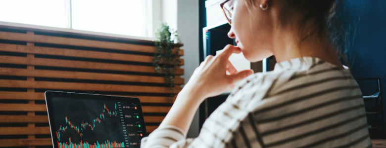 A woman on her laptop investing