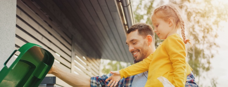 A father and daughter recycling