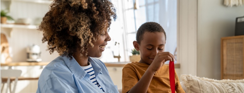 A mum giving a gift to her son.
